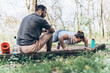 © BalanceFormCreative - Sitting on a fallen tree trunk, the couple, including the determined overweight female, catch their breath, their laughter blending with the rustling leaves as they enjoy a post-workout moment.
