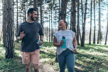 An inspiring scene unfolds as a beautiful, overweight female embarks on a jog in the park with her dedicated partner, embracing their journey to better health.	
