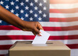 American Presidential election concept of hand voting in a USA Ballot Box