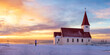 © ADDICTIVE STOCK - Anonymous person watching the sunset together a small Icelandic village with a church nestled between the sea