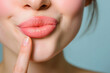 closeup woman with index finger on her lips