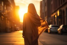 Islamic Woman Walking Down The Street Enjoying The Sunset