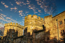Medieval Stone Castle At Sunset With Picturesque Clouds In The Sky In Lancaster.