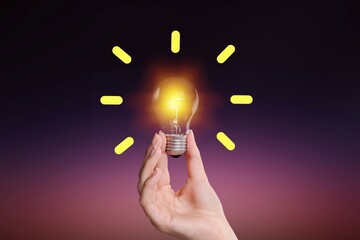 Poster - Creative idea. Businessman holding lamp light bulb.