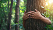 © Argun Stock Photos - Hands hugging a tree in the forest. Love nature concept.