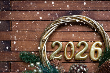 Happy New Year golden numbers 2026 on cozy festive brown wooden background with sequins, snow, lights of garlands. Greetings, postcard. Calendar, cover