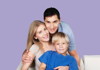 Wall Mural - Young smiling happy parents with child