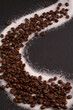 © Yaraslava - In this close-up photo, a group of coffee beans creates a textured background, emanating the rich aroma of caffeine. With copy space, the image emphasizes the aromatic quality of these coffee beans
