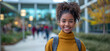 © TEERAPONG - Confident African American female student back to school, her bright turtleneck matching the vibrant fall foliage on campus.