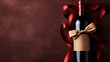 Red Wine Bottle with Golden Bow and Elegant Ribbon on Textured Maroon Background
