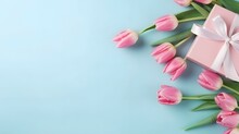 Mother S Day Atmosphere Concept. Top View Photo Of Bunch Of Pink Tulips And Pink Gift Boxes With Ribbon Bows On Isolated Pastel Blue Background With Empty Space