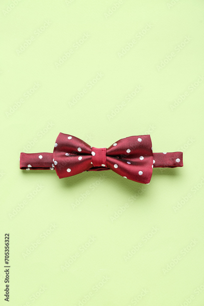 Stylish bow tie on color background