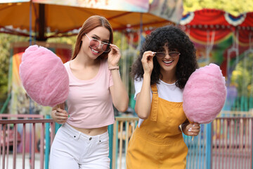 Wall Mural - Happy friends with cotton candies at funfair