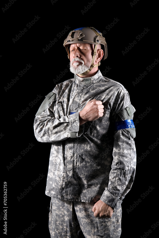 Ukrainian soldier on dark background