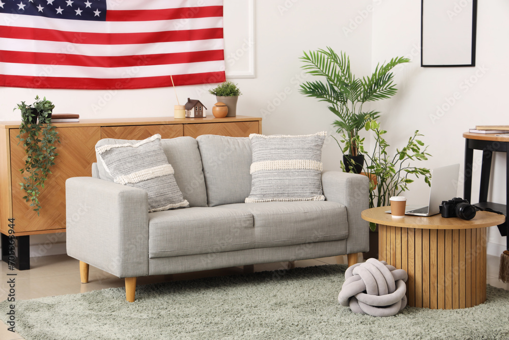 Interior of living room with USA flag, table and sofa