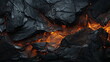 © seogi - Close-up of hot lava spouting from a volcano flowing through black rocks. Lava, coal texture background.