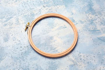 Wall Mural - Wooden embroidery hoop on grunge blue background