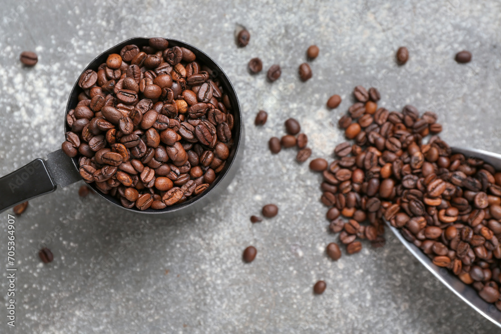 Cezve with coffee beans on grey background