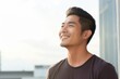Portrait of a young handsome asian man smiling and looking away