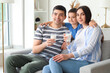 © Pixel-Shot - Little boy hugging his parents with milk at home