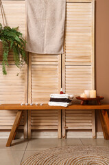 Canvas Print - Burning candles with towels on table in spa salon