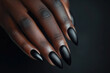 © saulo_arts - Hand of a black woman posing for black nail polish advertisement