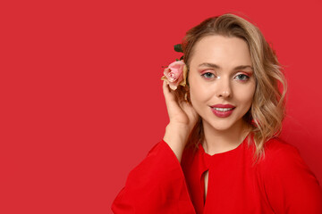 Poster - Young woman with beautiful rose on red background