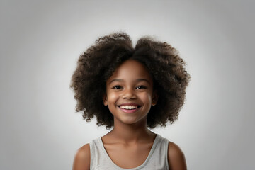 Studio portrait of a young black girl with a big curly afro hairstyle smiling at the camera. Beauty and skincare image. dental advertisement. Web design banner.