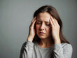 © BNMK0819 - Woman with migraine headache holding her head in pain
