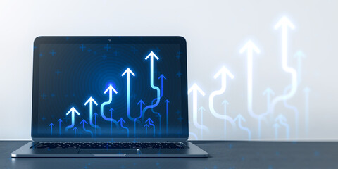 Wall Mural - Close up of laptop computer at workplace with growing blue business chart arrows on blurry background. Success, trend and financial growth concept. 3D Rendering.