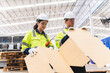 © chokniti - Professional worker team in safety uniform, supervisor inspector in packaging stock order at cardboard factory warehouse, piles of stacking paper manufacture, recycling industrial production