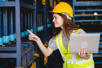 Portrait female professional engineer factory in protective uniform operating machine, Engineering worker in safety hardhat at warehouse industrial facilities, Heavy Industry Manufacturing