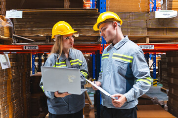 Wall Mural - Female engineer using laptop computer for safety control checks or manufacturing maintenance work in factory building or construction site. woman engineer inspector working in industry product line