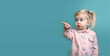 © Olya Fedorova - Little girl on a blue background shows her finger up