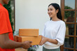 © itchaznong - Young Asian cute girl receiving boxes from postman at the door. Delivery concept
