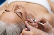 © zinkevych - Woman having anti wrinkle filler injections to eye area