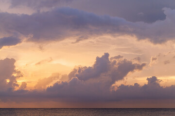 Wall Mural - colorful clouds of tropical sky over the ocean at sunset