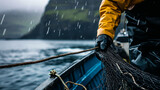 Fototapeta  - Close up of a Fisherman in rough weather handling nets on his boat. Concept of industrial fishing. Shallow field of view.
