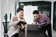 © Nuttapong punna - Kind leader executive manager share and discuss business solutions plan ideas on tablet with Asian male marketing manager in modern office..