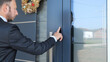 Business man using fingerprint to unlock smart key home entrance