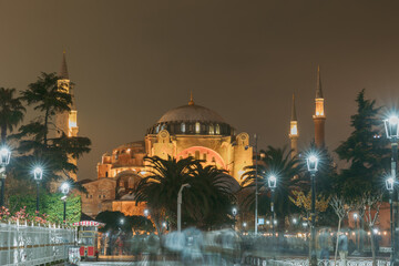 Hagia Sophia or Ayasofya at night with motion blur of people.