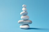 Fototapeta Desenie - White sea pebble stone stack on light blue background.