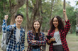 © NINENII - Happy group of college students use laptop feel excited overjoyed with good news over smartphone or Tablet.