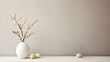 Minimalistic Easter still life. A vase with a branch with flowers and Easter eggs on a beige background. Interior photography. springtime.