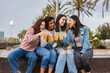 © PintoArt - group of multiracial friends having refreshments together on the beach
