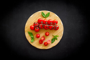 Wall Mural - Tomatoes and basil on wooden board, top view. Cooking background