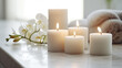 A serene setting with lit white candles and a delicate orchid branch, creating a peaceful and inviting atmosphere