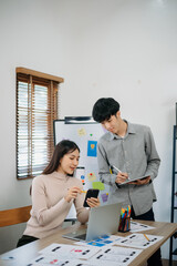 Wall Mural - Close up view of UI developer team brainstorming on their project with laptop, smartphone and digital tablet.