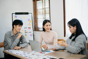 Wall Mural - Close up view of UI developer team brainstorming on their project with laptop, smartphone and digital tablet.