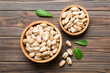 Fresh healthy Pistachios in bowl on colored table background. Top view Healthy eating concept. Super foods